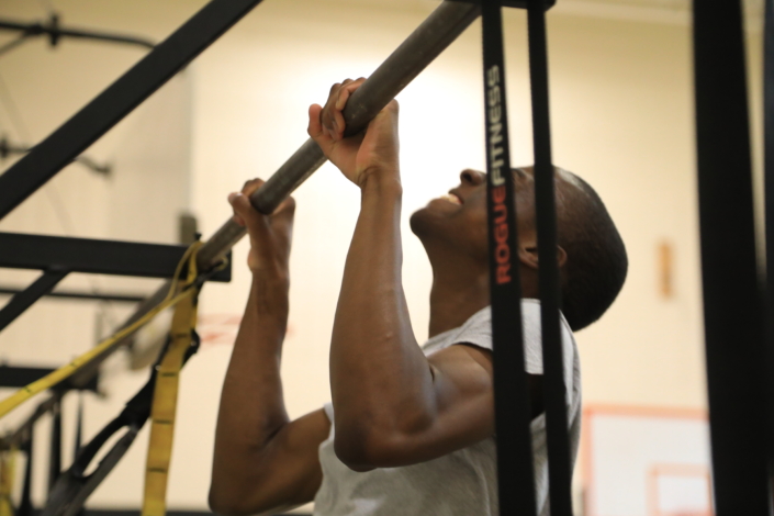 Image shows a recruit doing a pull up.