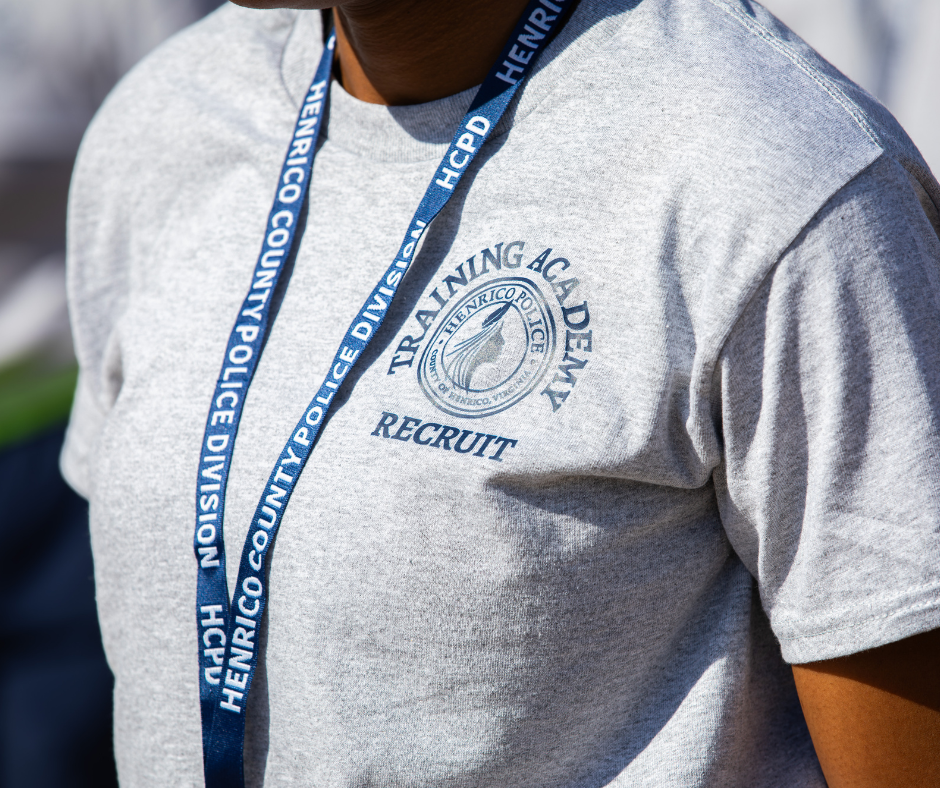 Police recruit in PT gear Henrico Police Recruit wearing an academy t-shirt and a lanyard.