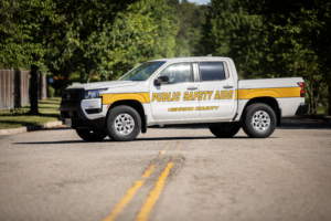 Henrico County Public Safety Aide pick-up truck on a road with trees in the background.